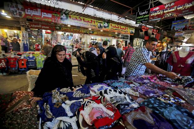 Iraqi civilians shop in the souk in the East of Mosul, Iraq, July 22,2017