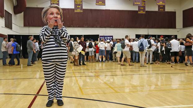 Trump supporter Beth Lyerla of Gilbert, Ariz., wears a Clinton mask and a prison outfit as she waits for Donald Trump Jr. to speak at a campaign rally at Arizona State University on Oct. 27, 2016, in Tempe, Ariz.