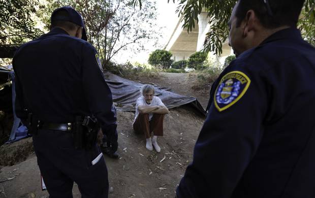 Police encourage homeless man Stephen Schofield to get a hepatitis A vaccination near where Mr. Schofield is living along the San Diego River in San Diego. A recent hepatitis A outbreak reflects how much homelessness has become a crisis in San Diego.