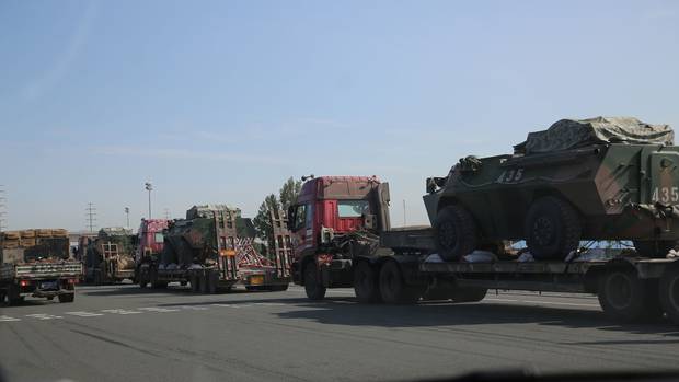 Military equipment moves down a highway in Xinjiang, where the Chinese government has responded with a massive display of force to what it calls extremist activity in the area.