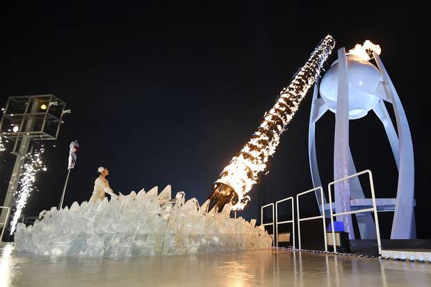 South Korean Olympic figure-skating champion Yuna Kim lights the Olympic flame.