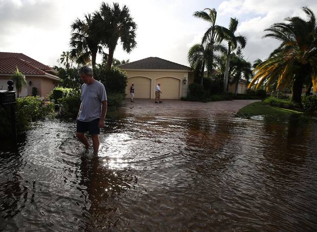 Bonita Springs, Fla., Sept. 11: People inspect their flooded neighborhood.