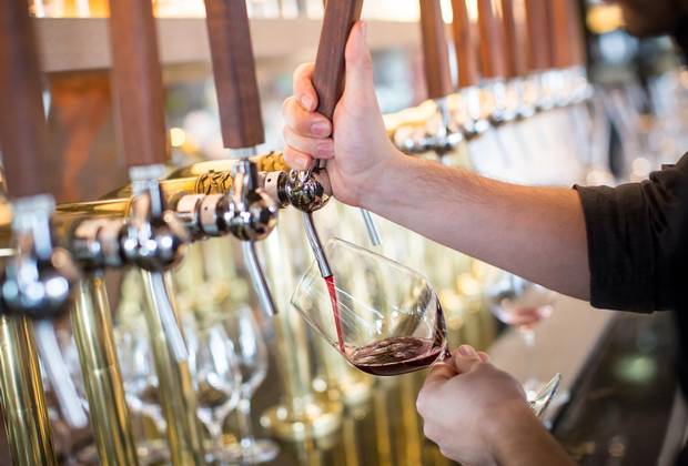 Darcy Golby pours a glass of red wine from the taps at Provence Marinaside.