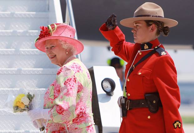 An RCMP officer salutes the Queen as she boards a plane at Toronto’s Pearson International Airport on July 6, 2010.