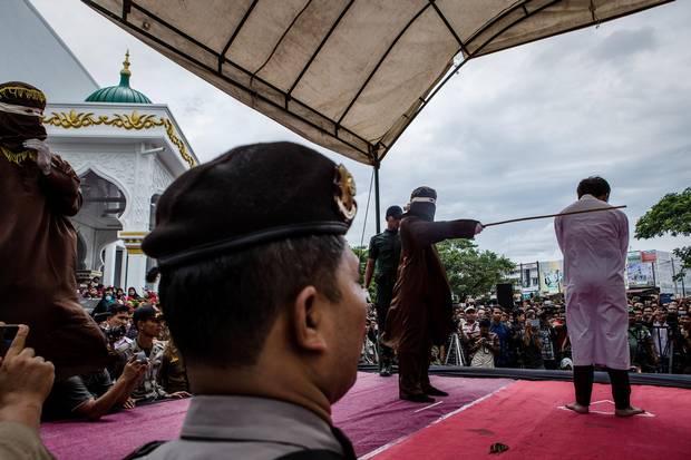 An Indonesian man is caned in public for having gay sex, which is against Sharia law, at Syuhada mosque in Banda Aceh, Indonesia on May 23, 2017