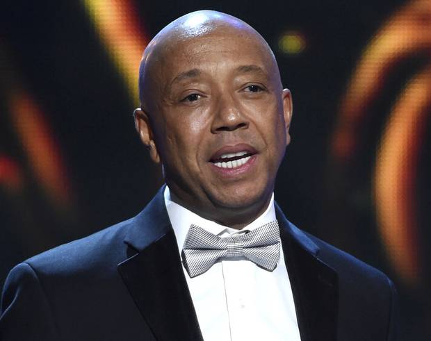 In this Feb. 6, 2015, file photo, hip-hop mogul Russell Simmons presents the Vanguard Award on stage at the 46th NAACP Image Awards in Pasadena, Calif. Simmons announced on Nov. 30, 2017, he would be stepping down from companies he founded following a new allegation of sexual misconduct.