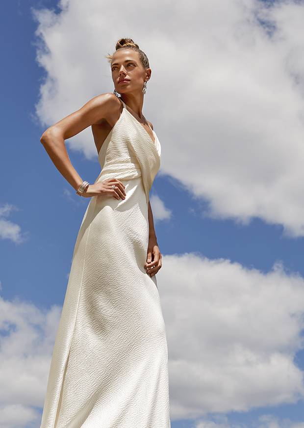 An ivory Elizabeth Fillmore gown in a textured textile finds inspiration in a more ancient Grecian version of Olympic attire. Elizabeth Fillmore dress, price on request at Kleinfeld at Hudson’s Bay. Dean Davidson earrings, $250 through www.deandavidson.ca. Bracelet, $2,125, ring, $1,500 at David Yurman.