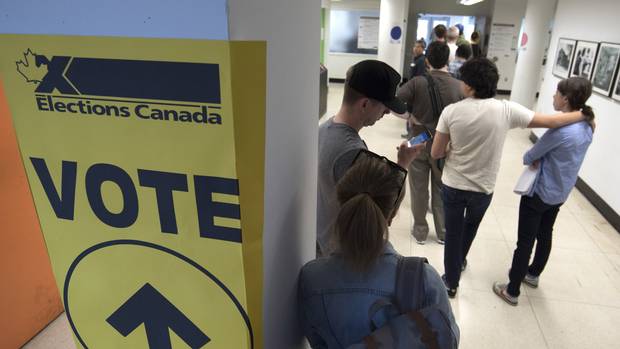 Voters wait at an advance poling station in downtown Toronto on Oct. 12, 2015.