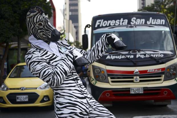 A man dressed in a zebra costume performs on the streets of Medellin, Colombia, for Car and Motorcycle Free Day on April 22, 2015.