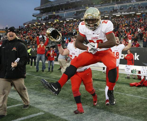 Christopher Amoah of the Laval Rouge et Or leaps in the air as his team begins to celebrate their victory over the Calgary Dinos in the U Sports Vanier Cup national championship in Hamilton last November.