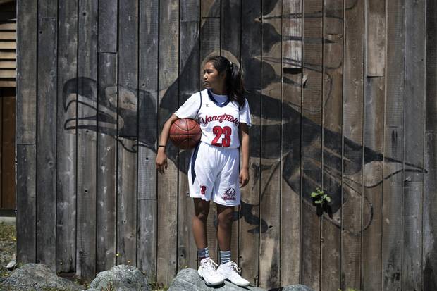Sereana Kaloucokovale, 14, who is a point guard for the Maaqtusiis Thunder, poses for a photo outside of the school in Ahousaht, on Flores Island, in Clayoquot Sound. Melissa Renwick