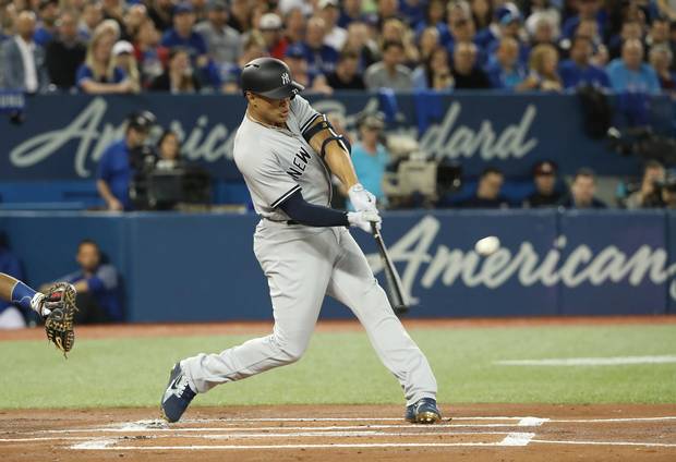 Giancarlo Stanton of the New York Yankees hits a two-run home run against the Toronto Blue Jays in the first inning of the Jays’ 2018 home opener.