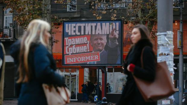 Pedestrians stand by a billboard of U.S. President Donald Trump with the inscription ‘Congratulations! Trump Serb!’ in Belgrade in November, 2016.