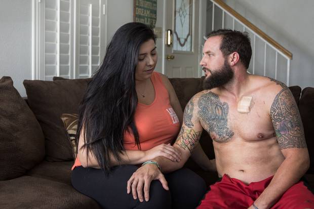 Las Vegas survivors William King and his wife, Kimberly King, sit in their home after returning from the hospital, where Mr. King was treated for a gunshot wound to the chest.