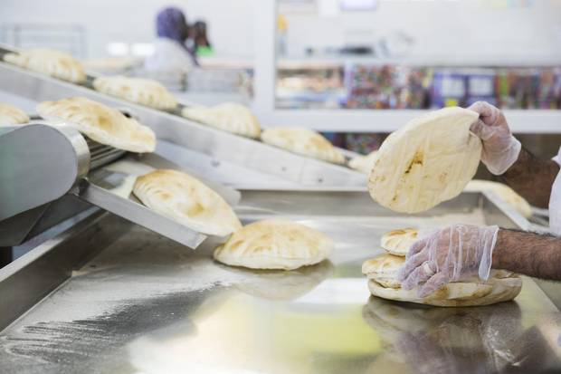 A large industrial oven at the centre of Adonis grocery store is used to prepare fresh pitas.