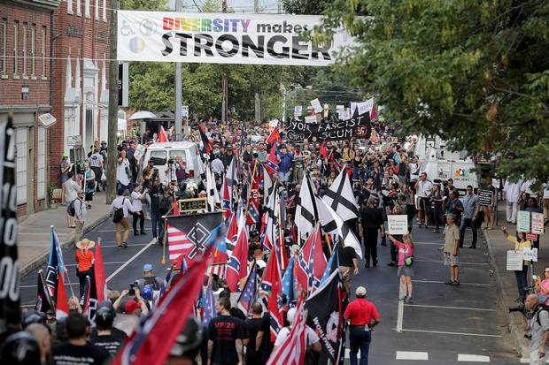 Hundreds of white nationalists and neo-Nazis march down East Market Street toward Lee Park during the 