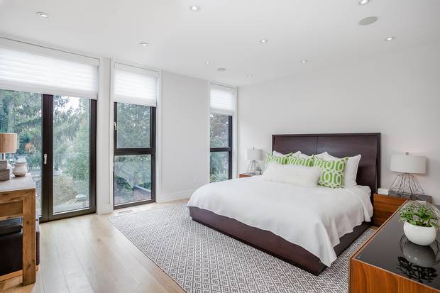 The master suite has floor-to-ceiling windows and a French balcony.