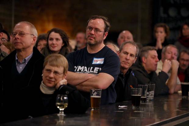 Attendees look on as Democratic presidential candidate Martin O'Malley speaks during a campaign event at the Torrent Brewing Company on January 27, 2016 in Ames, Iowa.