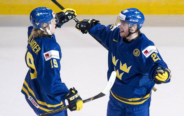 Sweden's Alexander Nylander, left, celebrates his empty-net goal with teammate Sebastian Ohlsson as they face Finland during third period IIHF World Junior Championship hockey action Thursday, December 29, 2016 in Montreal. Nylander leads the tournament with five goals and 11 points in five games.