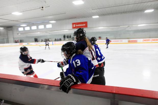 Nunavik Nordiks Noemie Koneak (13) is checked into the boards during a game March 24, 2017 in Ottawa. The Inuit girl's hockey team is in Ottawa for a tournament. DAVE CHAN / THE GLOBE AND MAIL