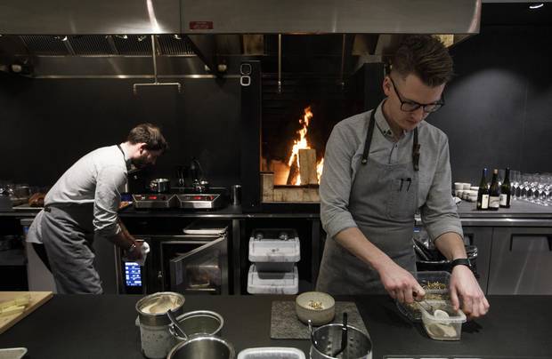 Chef and co-owner Ben Staley, right, prepares Sunchoke ice cream at the Alder Room restaurant in Edmonton on Thursday.