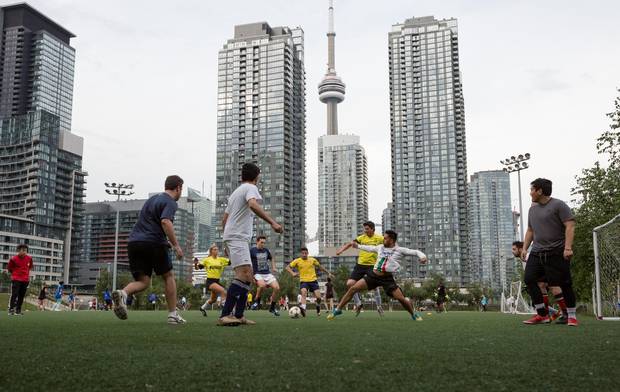 A soccer game takes place on the turf field at Canoe Landing Park in CityPlace
