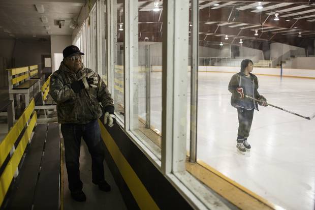 Sasakamoose watches kids play hockey in the arena at the Ahtahkakoop Cree Nation named after him.