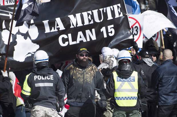 Police hold back far-right protesters during a demonstration in Montreal, Saturday, March 4, 2017.