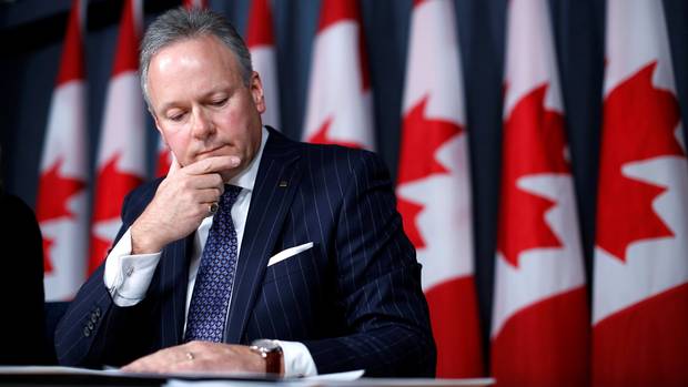 Mr. Poloz looks over papers during a news conference in Ottawa in April.