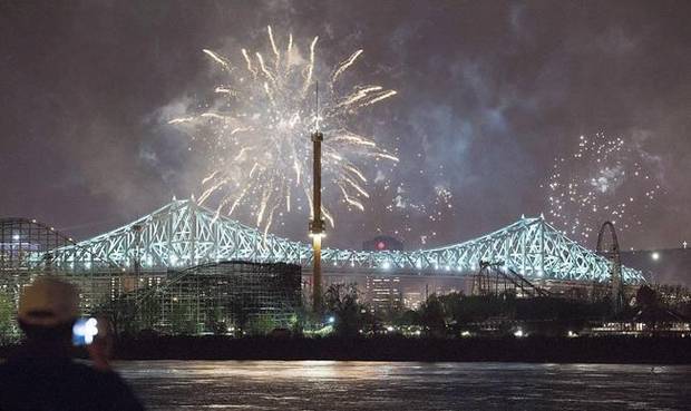 Fireworks explode over an illuminated Jacques Cartier Bridge on May 17, 2017, to celebrate the city's 375th birthday.
