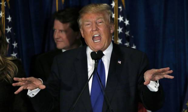Republican U.S. presidential candidate Donald Trump reacts at his 2016 New Hampshire presidential primary night rally in Manchester, New Hampshire February 9, 2016.
