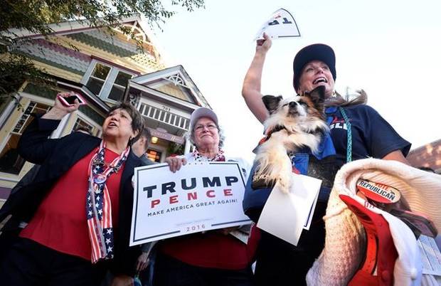 Donald Trump supporters Mary Claire, from left, Colette McDonald and Karolee McLaughlin, with her dog Lakota, spar with protesters in Boulder, Colorado, on Monday.