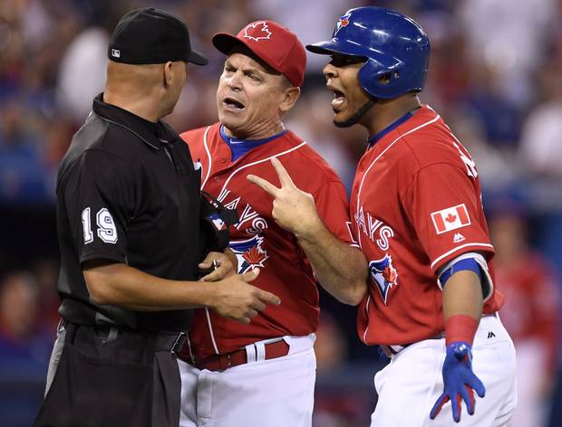 Toronto Blue Jays manager John Gibbons, centre, and designated hitter Edwin Encarnacion exchange words with umpire Vic Carapazza (19) after Encarnacion was ejected from the game over a call-out on strikes during first inning MLB baseball action, in Toronto on Canada Day, Friday, July 1, 2016. The confrontation resulted in Gibbons also getting ejected from the game.