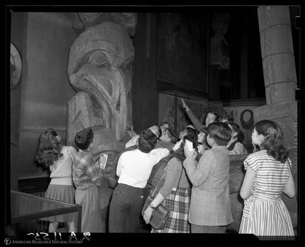 A public-school class takes a tour of the Northwest Coast Hall in 1947.
