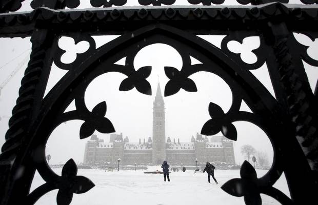 People walk on Parliament Hill during the snowstorm.
