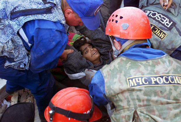 Kuntal Thakkar, 22, is brought out by a Russian rescue team on Jan. 31, 2001, after surviving six days under tons of earthquake rubble in Bhachau, western India.