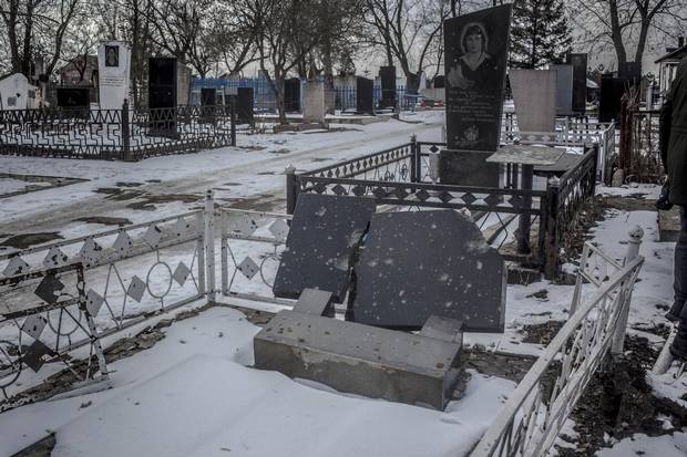 Tombstones damaged by rockets in the cemetry in Sartana.