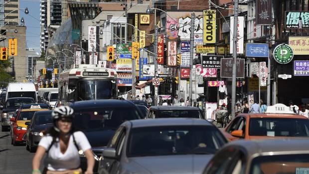Rush hour commuters in Toronto's Chinatown.