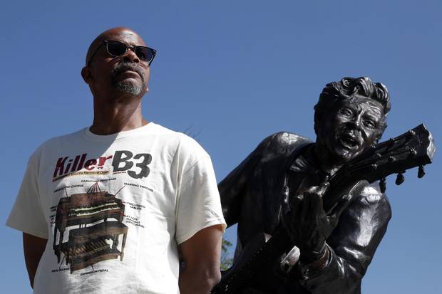 Charles Berry Jr., son of rock ‘n’ roll legend Chuck Berry, stands with a statue of his late father in Missouri on May 31.