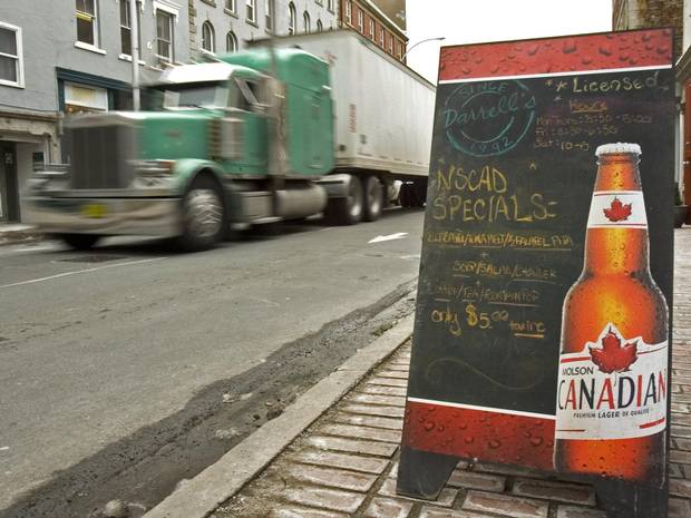 A truck passes a sign advertising Molson beer in Halifax.