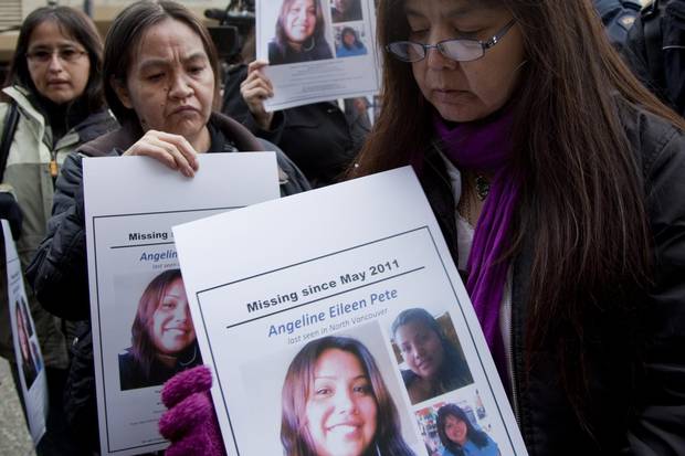 Molly Dixon, right, mother of Angeline Pete, holds up a picture of her missing daughter during a news conference outside the missing and murdered Indigenous women inquiry in Vancouver on Oct. 24, 2011.