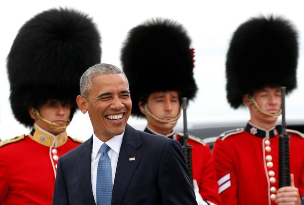 U.S. President Barack Obama smiles as he walks past an honor guard upon arrival to attend the North American Leaders' Summit in Ottawa.