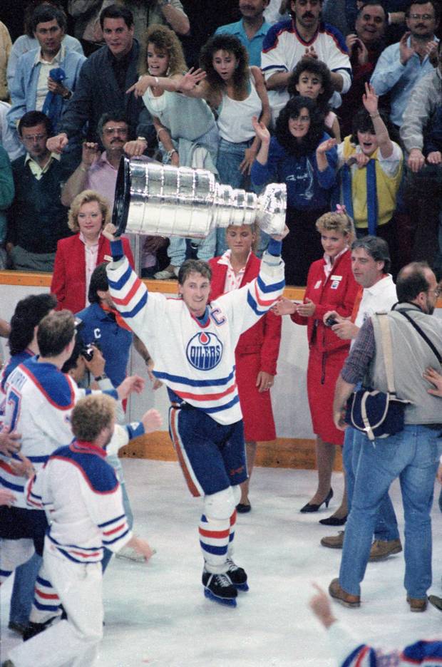 Canadian hockey player Wayne Gretzky #99 of the Edmonton Oilers raises the Stanley Cup over his head in victory after the Oilers defeated the Philadelphia Flyers, Edmonton, Alberta, Canada, May 31, 1987.