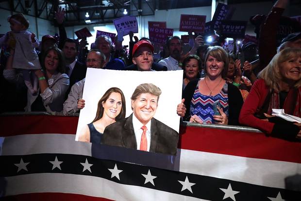 A Trump supporter holds a painting of the Republican candidate and his wife, Melania, at a campaign rally the Reno-Sparks Convention Center in Reno, Nevada, on Nov. 5, 2016. Nevada is a crucial swing state for both candidates.