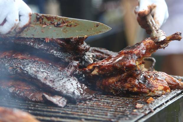 Flipping ribs on the Boss Hog's grill at the St. Thomas, Ribfest on Saturday July 25, 2015. 