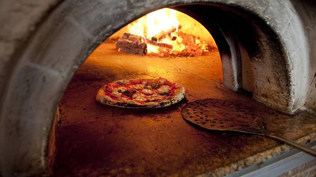 Pizza being made in the wood-fired oven at Motorino in Williamsburg, Brooklyn in July 2009.