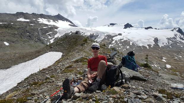 Annelies Ebner on a break from hiking in the Selkirk Mountains of British Columbia, the Allalin Glacier behind her.
