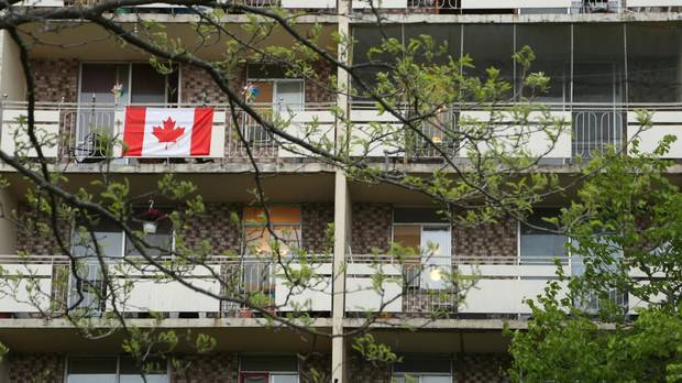 A Canadian flag flies from an apartment balcony in the Riverdale neighbourhood of Hamilton, Ont. Riverdale is a high-rise immigrant neighbourhood with the third-largest concentration of immigrants in Canada, and growing fast.