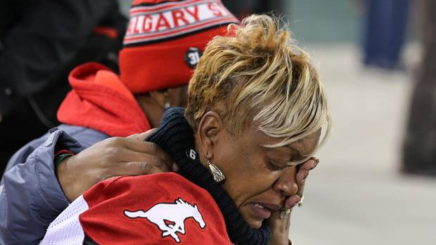 Renee Hill, mother of Mylan Hicks, a member of the Calgary Stampeders that was recently killed in Calgary is comforted on the sidelines before the Canadian Football League's (CFL) 104th Grey Cup championship game in Toronto, Ontario, Canada November 27, 2016.