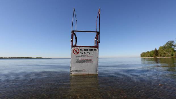 A lifeguard stand sits in high water at Ward's Island Beach where sand used to span out beyond it.